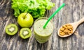 Healthy green smoothie with kiwi, apple on rustic wood background. Royalty Free Stock Photo