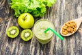 Healthy green smoothie with kiwi, apple on rustic wood background. Royalty Free Stock Photo