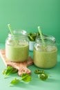 Healthy green smoothie with spinach mango banana in glass jars Royalty Free Stock Photo