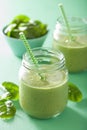 Healthy green smoothie with spinach mango banana in glass jars Royalty Free Stock Photo