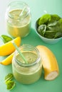 Healthy green smoothie with spinach mango banana in glass jars Royalty Free Stock Photo