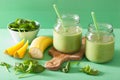 Healthy green smoothie with spinach mango banana in glass jars Royalty Free Stock Photo