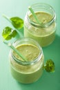 Healthy green smoothie with spinach mango banana in glass jars Royalty Free Stock Photo