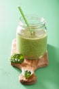 Healthy green smoothie with spinach mango banana in glass jars Royalty Free Stock Photo