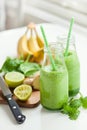 Healthy green spinach smoothie with cilantro lime banana ginger Royalty Free Stock Photo