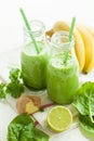 Healthy green spinach smoothie with cilantro lime banana ginger Royalty Free Stock Photo