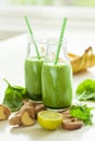 Healthy green spinach smoothie with cilantro lime banana ginger Royalty Free Stock Photo