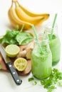 Healthy green spinach smoothie with cilantro lime banana ginger Royalty Free Stock Photo