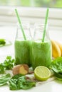 Healthy green spinach smoothie with cilantro lime banana ginger Royalty Free Stock Photo