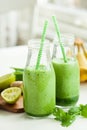 Healthy green spinach smoothie with cilantro lime banana ginger Royalty Free Stock Photo