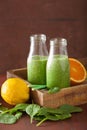 Healthy green spinach smoothie with lemon orange Royalty Free Stock Photo