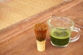 Healthy green tea in cup and bamboo whisk. Royalty Free Stock Photo