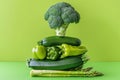 Healthy green vegetable stack featuring broccoli, peppers, zucchini and asparagus on bright lime background Royalty Free Stock Photo