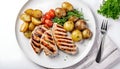 Healthy grilled chicken breasts with potatoes and fresh vegetable on the side in a Plate isolated on white background Royalty Free Stock Photo