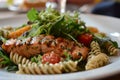 Healthy grilled salmon with pasta and salad on a plate