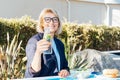 Healthy habit to drink water. Smiling middle aged business woman with bottle of water with lemon and mint during her Royalty Free Stock Photo