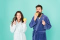 Healthy habits. Brush teeth every morning. Oral hygiene. Couple bathrobes hold toothbrushes and apples. Personal hygiene