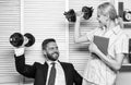 Healthy habits in office. Man and woman raise heavy dumbbells. Strong powerful business strategy. Good job concept. Boss Royalty Free Stock Photo