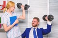 Healthy habits in office. Man and woman raise heavy dumbbells. Strong powerful business strategy. Good job concept. Boss Royalty Free Stock Photo