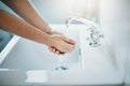 Healthy hand washing habits. hands being washed at a tap.