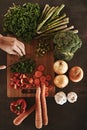 Healthy, hands and knife with vegetables, chopping board and food with ingredients and wellness. Closeup, utensils and Royalty Free Stock Photo