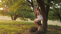 Healthy Happy Baby Boy. little girl is playing on a swing in a park on a tree. dream of flying. The concept of a happy Royalty Free Stock Photo