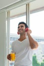 Healthy and happy handsome man listen music and drinking orange juice at home Royalty Free Stock Photo