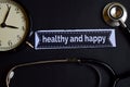 Healthy and Happy on the print paper with Healthcare Concept Inspiration. alarm clock, Black stethoscope.