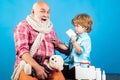 Healthy and health insurance concept. Boy doctor playing with dad. Elderly man with little cute doctor. Child boy Royalty Free Stock Photo