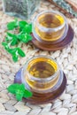 Healthy herbal mint tea in oriental glass cup with fresh peppermint and tea scoop on background Royalty Free Stock Photo