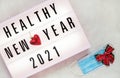 Healthy Holidays New Year concept banner during coronavirus COVID-19 time. Top view of disposable protective face mask with