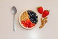 Healthy homemade breakfast. Yogurt with fresh fruits as strawberries, blueberries and nuts in a bowl with spoon on a wooden table Royalty Free Stock Photo