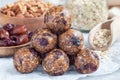 Homemade energy balls with cranberries, nuts, dates and rolled oats on parchment, horizontal Royalty Free Stock Photo