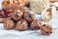 Healthy homemade energy balls with cranberries, nuts, dates and rolled oats on parchment, horizontal