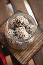 Healthy homemade energy balls with cranberries, nuts, dates and rolled oats on parchment, horizontal Royalty Free Stock Photo