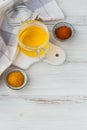 Healthy homemade Ghee or clarified butter in a jar, turmeric and paprika powder on white wooden table. Healthy Ayurveda food Royalty Free Stock Photo