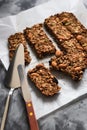 Healthy homemade gluten free sugar free vegan food. Oatmeal chocolate granola bars with almonds and amaranth seeds in baking paper Royalty Free Stock Photo