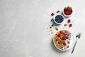 Healthy homemade granola with yogurt and berries served on light grey table, flat lay Royalty Free Stock Photo