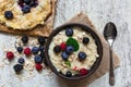 Healthy homemade oatmeal with berries and berry cake for breakfast. top view Royalty Free Stock Photo