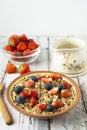 Healthy Homemade Oatmeal with Berries - fresh strwberries and blueberries, for Breakfast. Rustic white wooden table Royalty Free Stock Photo