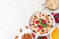 Healthy homemade oatmeal porridge with berries, nuts, honey and mint. diet breakfast food concept. top view Royalty Free Stock Photo