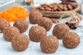 Healthy homemade paleo energy balls with carrot, nuts, dates and coconut flakes, on a parchment, horizontal Royalty Free Stock Photo