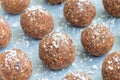 Healthy homemade paleo energy balls with carrot, nuts, dates and coconut flakes, on tray horizontal