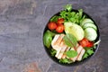 Healthy homemade salad bowl with avocado and chicken on a dark background Royalty Free Stock Photo