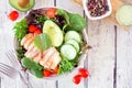 Healthy salad bowl with avocado and chicken, table scene on white wood Royalty Free Stock Photo