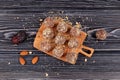 Healthy homemade sweets on dark wooden table, top view. Energy balls are a healthy snack. Balls of ground dried fruit and nuts Royalty Free Stock Photo