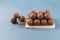 Healthy homemade sweets on a wooden cutting board. Energy balls are a healthy snack. Smooth balls on a blue background, place for Royalty Free Stock Photo