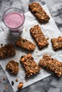 Healthy homemade vegan snack. Oatmeal chocolate granola bars with almonds and amaranth seeds and blueberry smoothie on baking Royalty Free Stock Photo