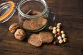 Healthy homemade wholegrain cookies on a rustic, wooden table with jar