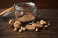 Healthy homemade wholegrain cookies on a rustic, wooden table with jar